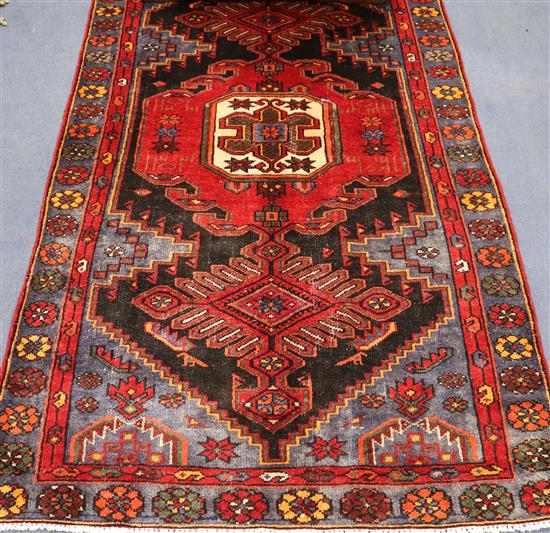 A Hamadan red and black ground rug, 6ft 11in by 4ft.